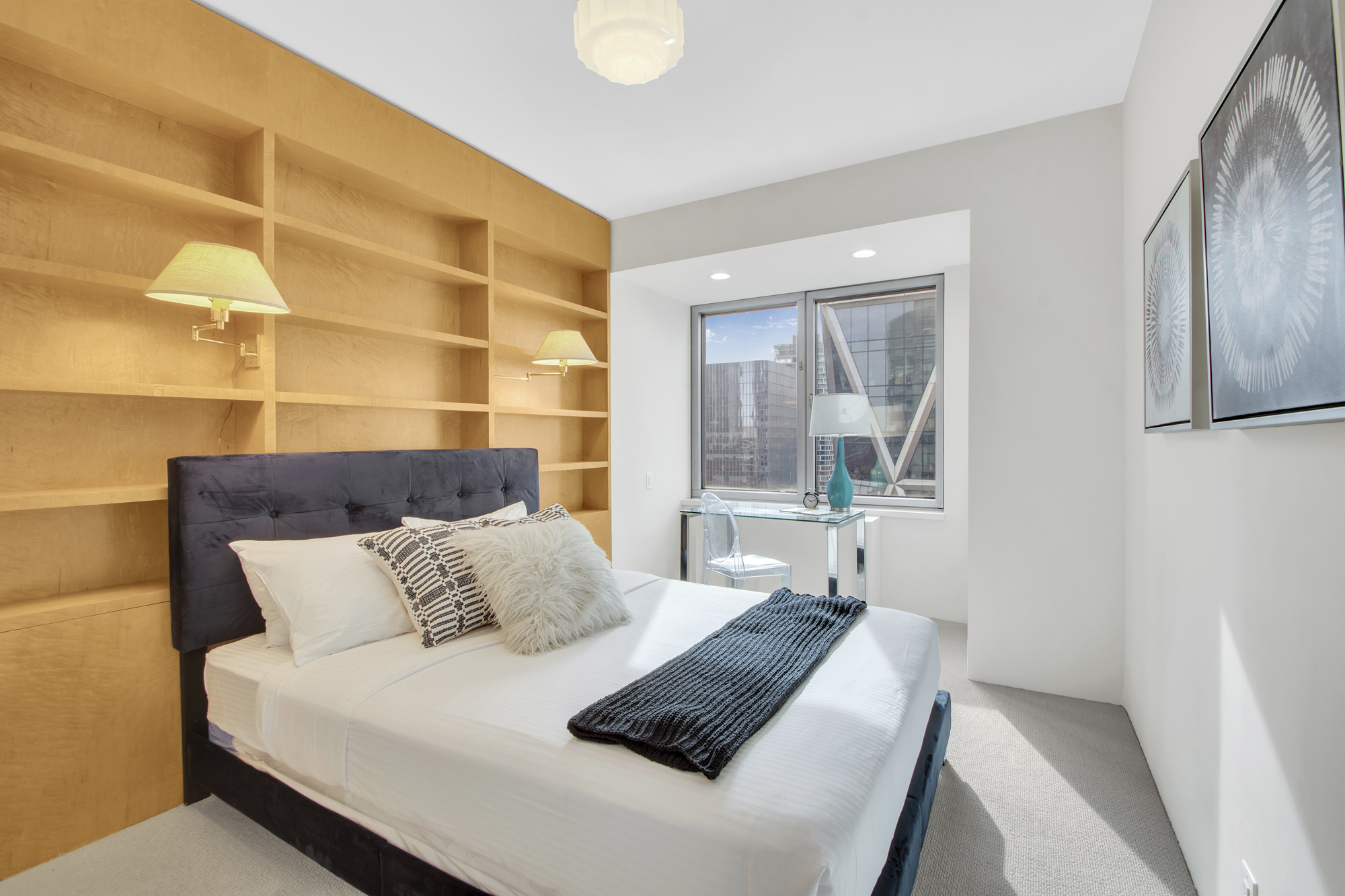 301 West 57th Street, Unit 48A Manhattan, NY 10019 - Photo 18 of 22 a bedroom with a bed and a window