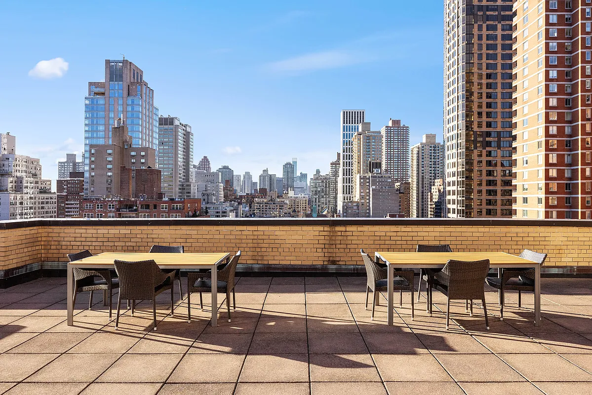 415 East 85th Street, Unit 7J Manhattan, NY 10028 - Photo 7 of 9 a view of chairs and table in the terrace