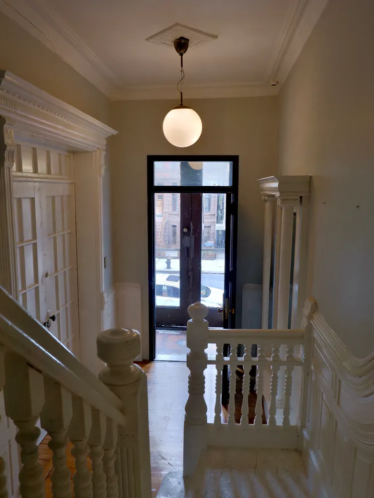 a view of a room with a large mirror and furniture
