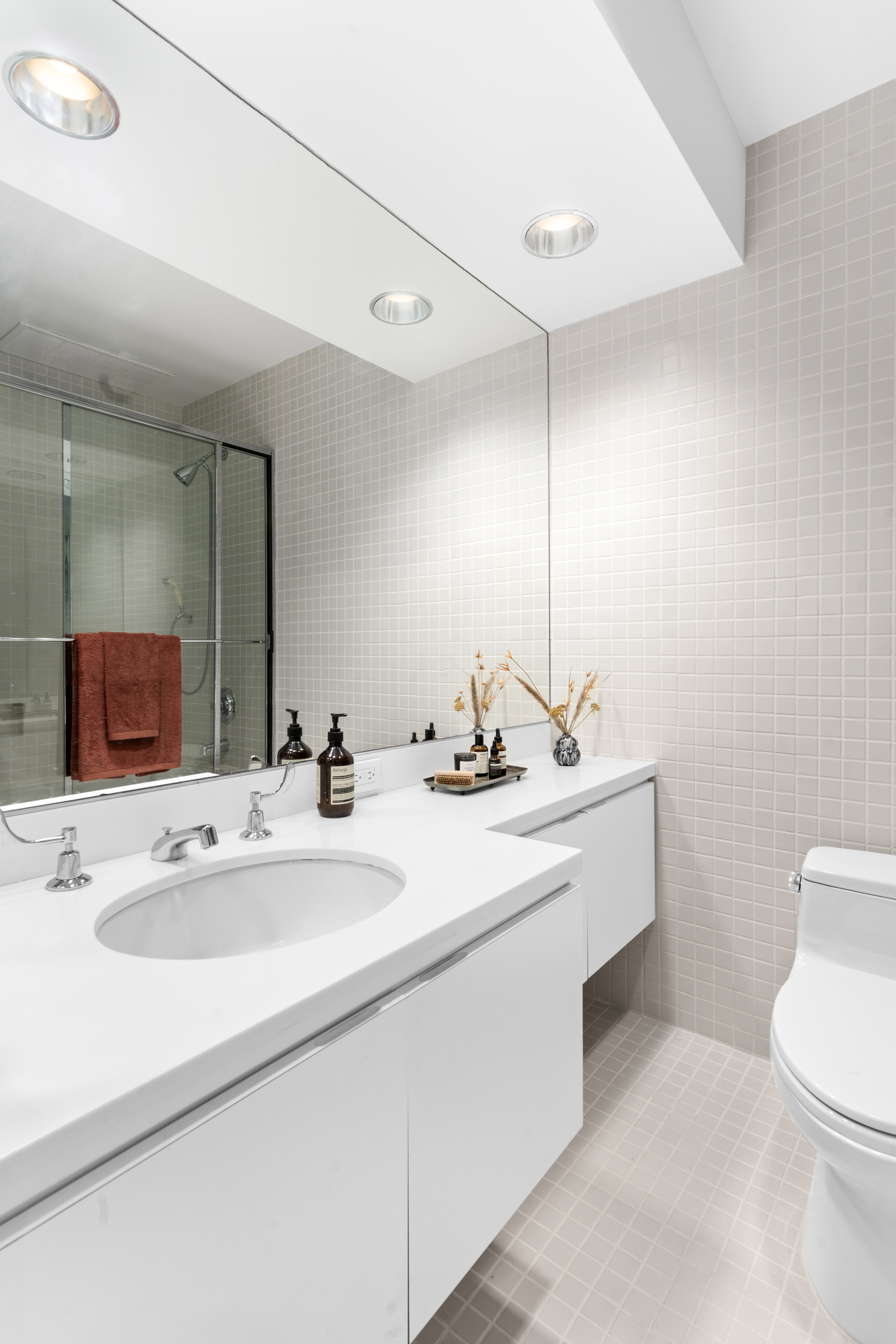 27 East 22nd Street, Unit F4 Manhattan, NY 10010 - Photo 11 of 15 a bathroom with a sink a toilet and mirror