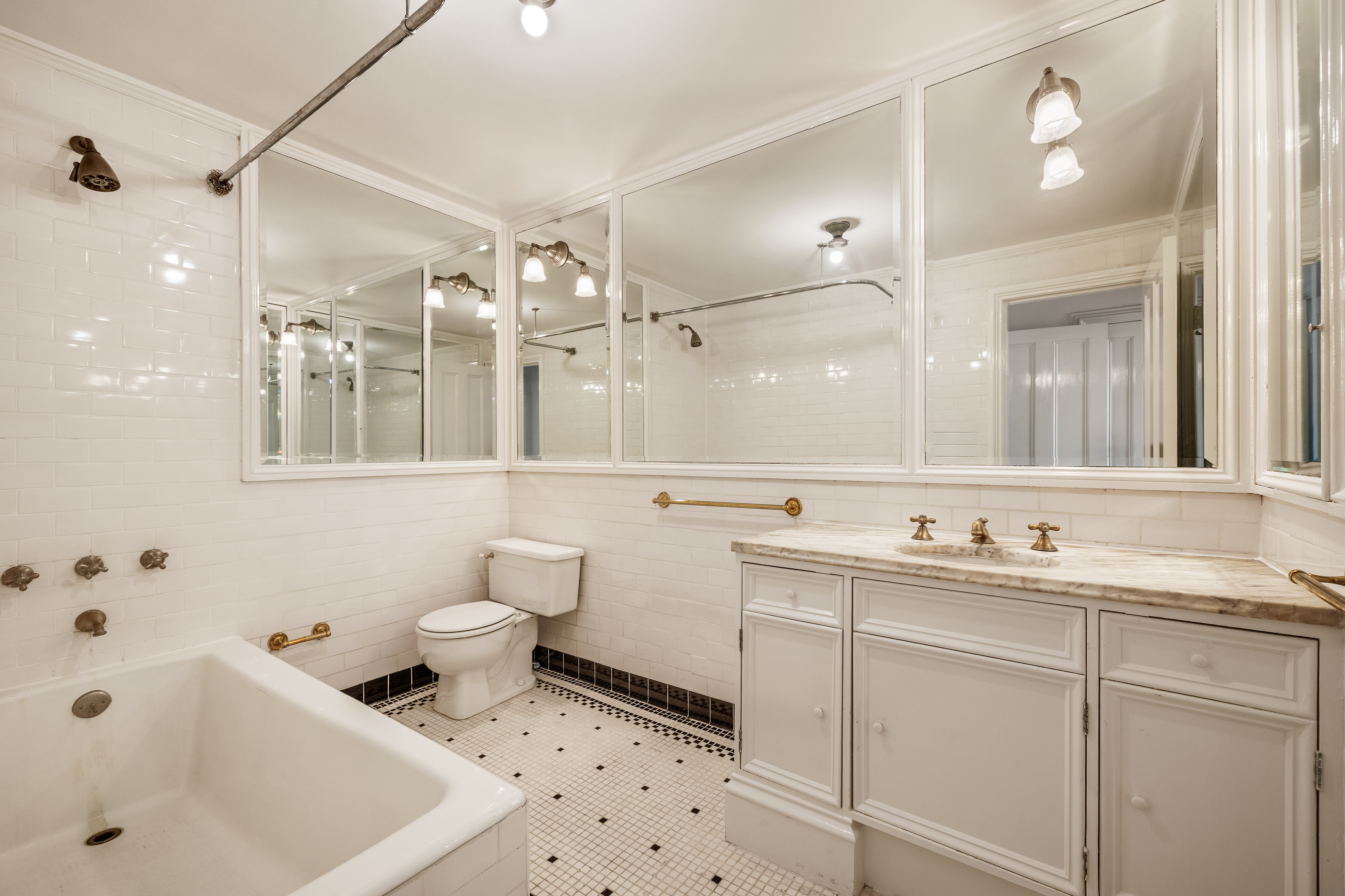225 West 22nd Street Manhattan, NY 10011 - Photo 9 of 12 a bathroom with a sink mirror and a toilet