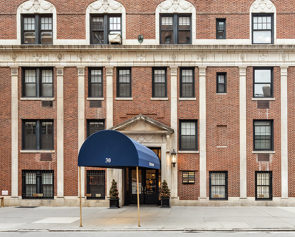 30 5th Avenue, Unit 16H Manhattan, NY 10011 - Photo 12 of 15 a front view of a residential apartment building with a yard