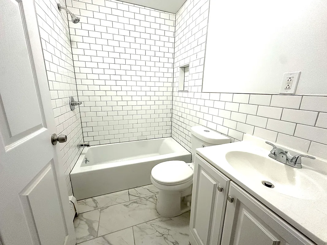 918 Dekalb Avenue, Unit 1 Brooklyn, NY 11221 - Photo 10 of 11 a bathroom with a sink toilet and shower