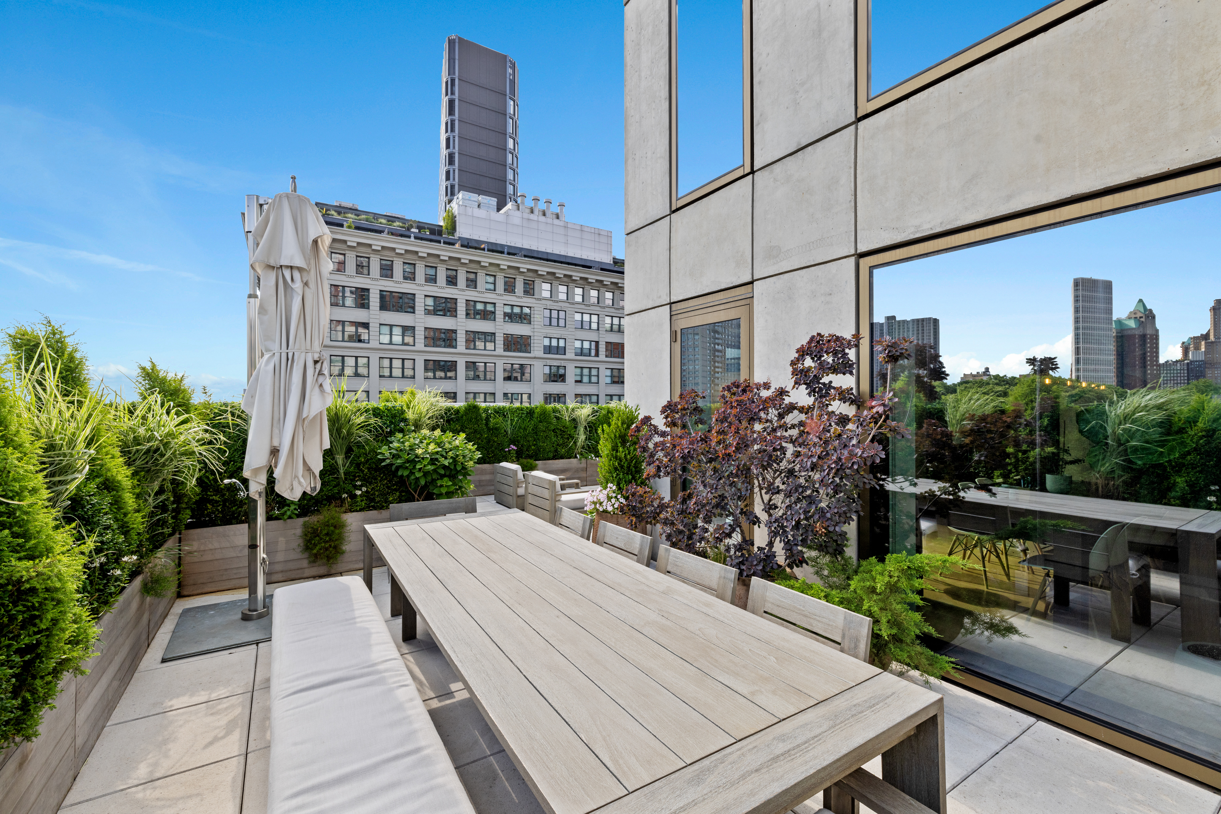 98 Front Street, Unit PH Brooklyn, NY 11201 - Photo 4 of 26 a view of a patio with table and chairs and potted plants
