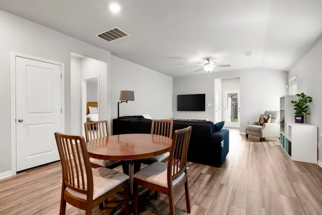 a view of a dining room with furniture and wooden floor