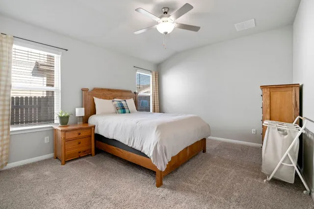 a bed room with a bed and a chair