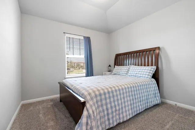 a bedroom with a bed and window