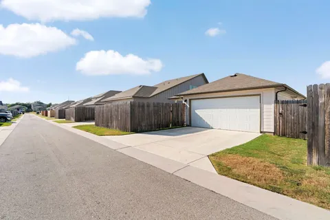 a view of a house with a yard and garage