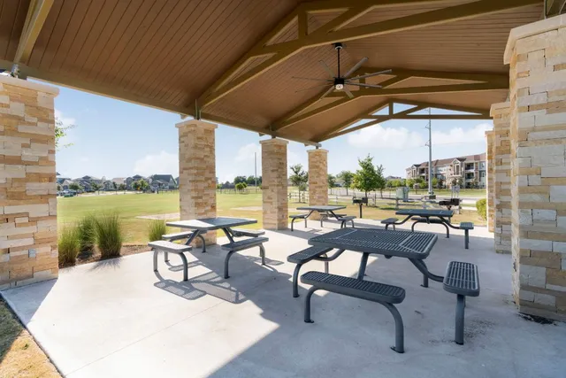 a swimming pool with outdoor seating and yard
