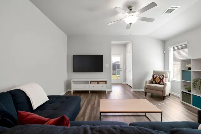 a living room with furniture and a flat screen tv