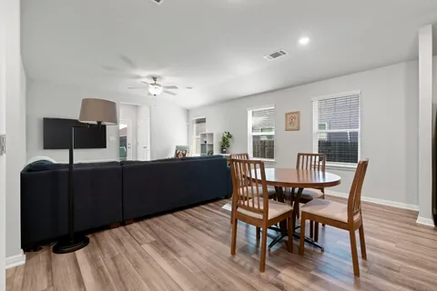 a view of a dining room with furniture and wooden floor