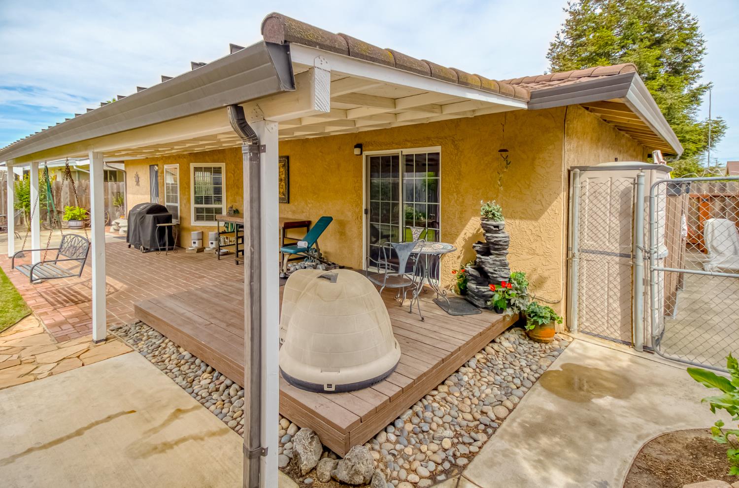 2016 Don Pedro Road Ceres, CA 95307 - Photo 22 of 28 Back patio showing the side of the home with more storage containers.
