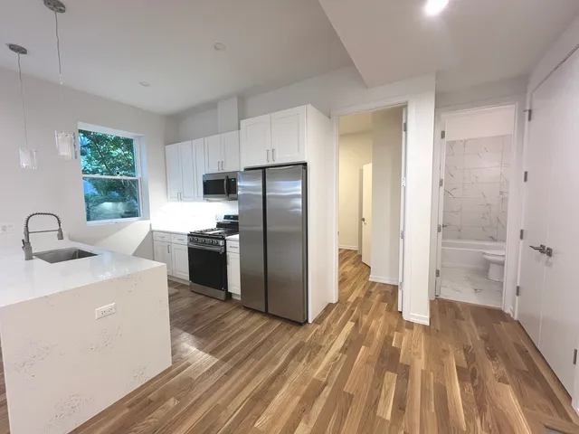 a kitchen with a sink a refrigerator and a stove