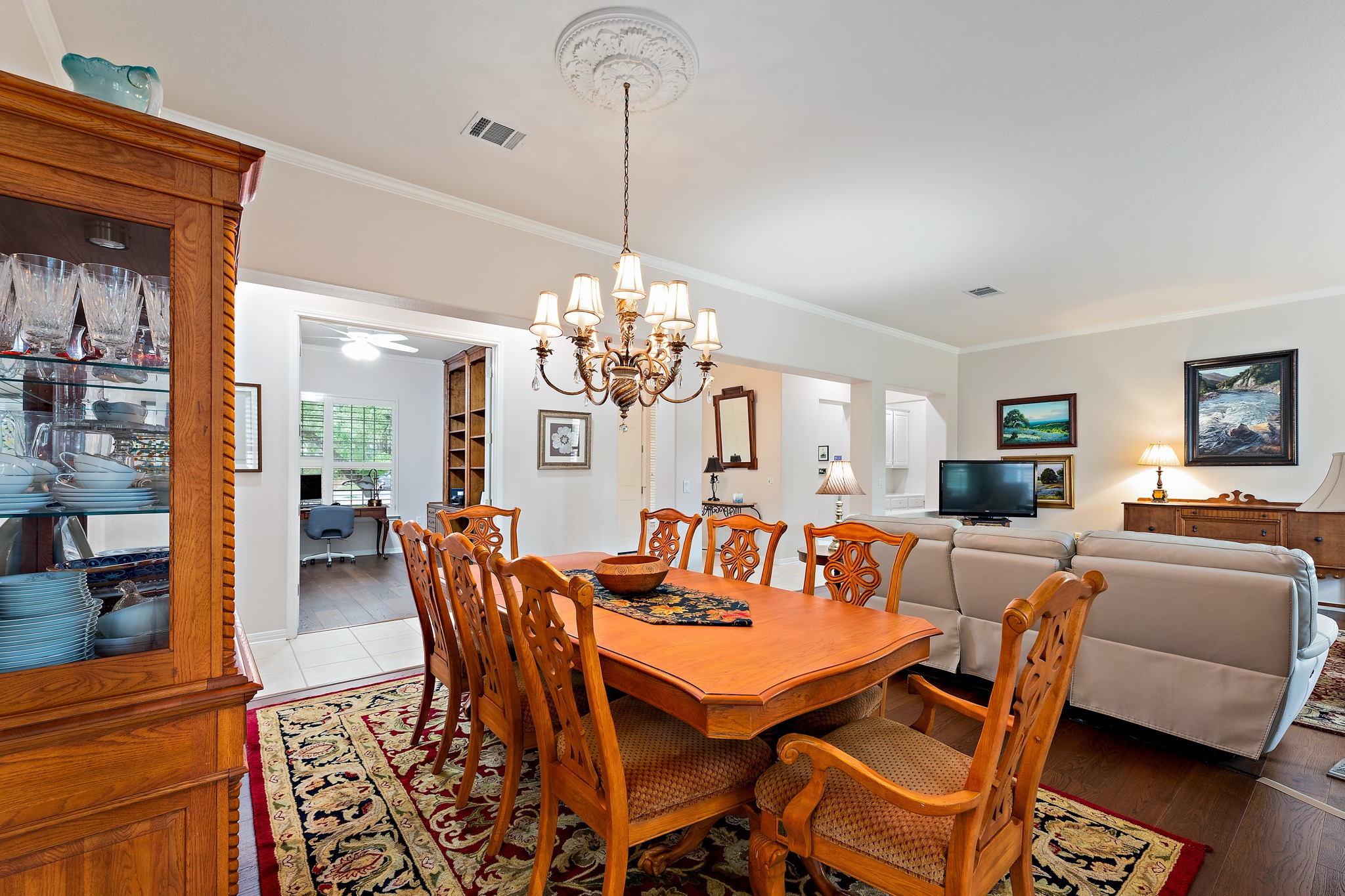106 Wild Turkey Lane Georgetown, TX 78633 - Photo 7 of 39 a dining room with furniture a chandelier and wooden floor