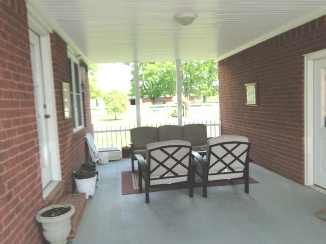 256 Edd Joyce Road Bell Buckle, TN 37020 - Photo 15 of 20 Covered patio in breeze way from sun room to oversized 2 car garage.