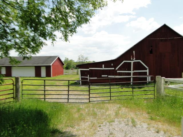256 Edd Joyce Road Bell Buckle, TN 37020 - Photo 19 of 20 Large red cattle barn, equipment shed, & garage/shop are the buildings on the farm.