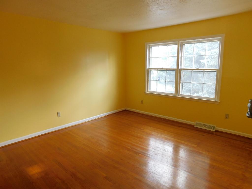 706 Ramada Road Vinton, VA 24179 - Photo 3 of 17 an empty room with wooden floor and windows