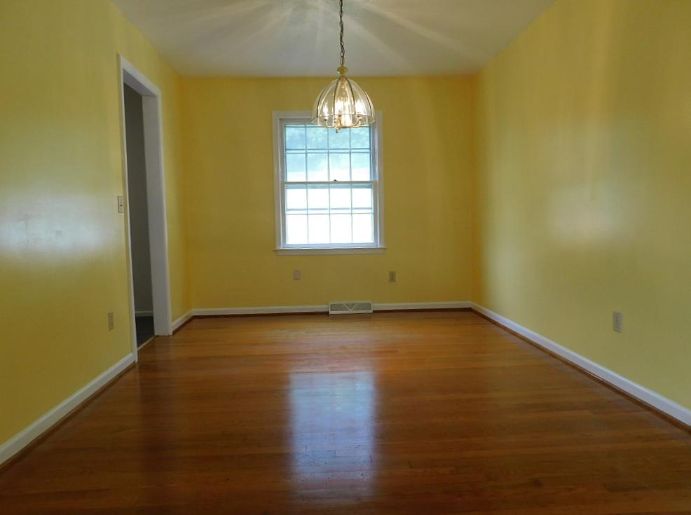 706 Ramada Road Vinton, VA 24179 - Photo 4 of 17 a view of an empty room with wooden floor and a window