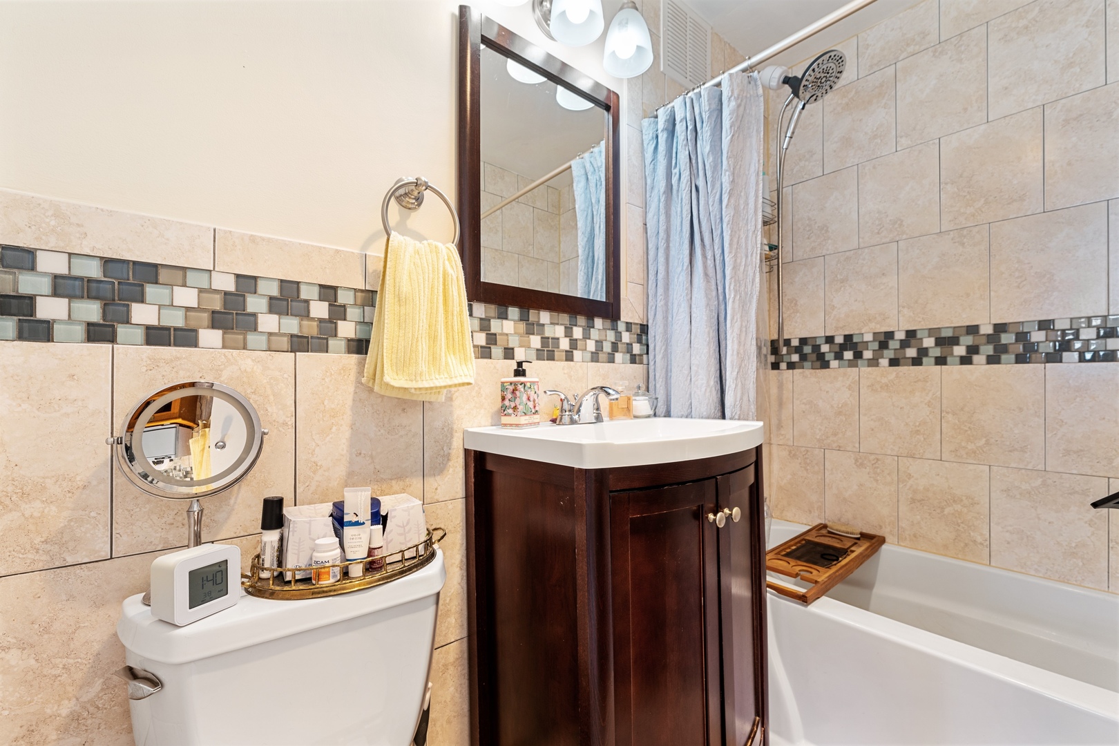 655 West Irving Park Road, Unit 1101 Chicago, IL 60613 - Photo 12 of 24 a bathroom with a sink mirror vanity and toilet