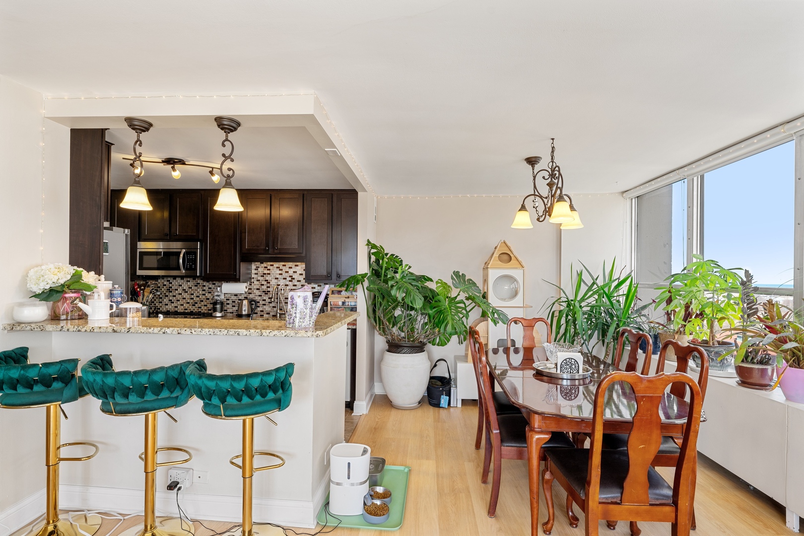 655 West Irving Park Road, Unit 1101 Chicago, IL 60613 - Photo 5 of 24 a view of a dining room with furniture and a chandelier