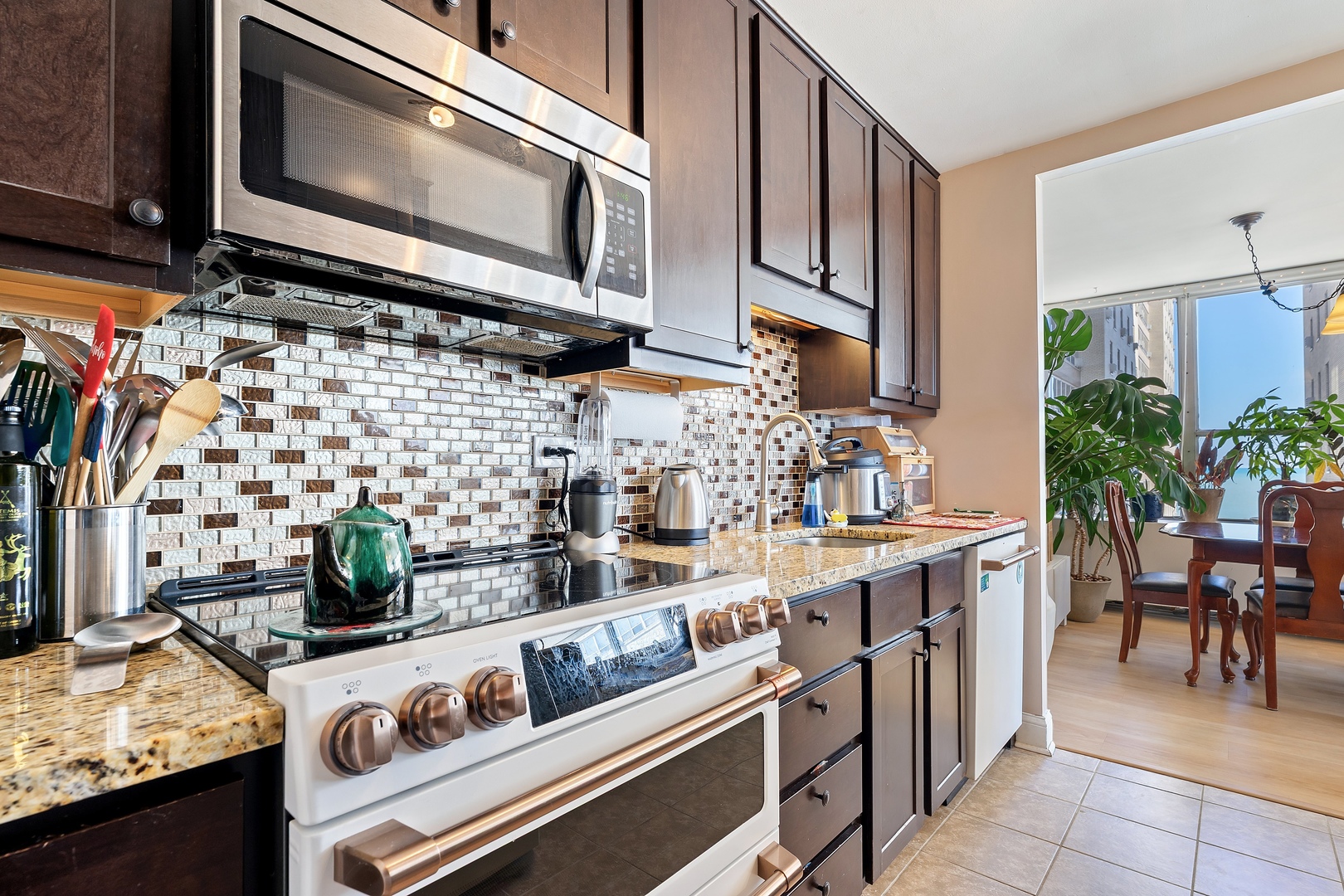 655 West Irving Park Road, Unit 1101 Chicago, IL 60613 - Photo 8 of 24 a kitchen with a stove and a microwave