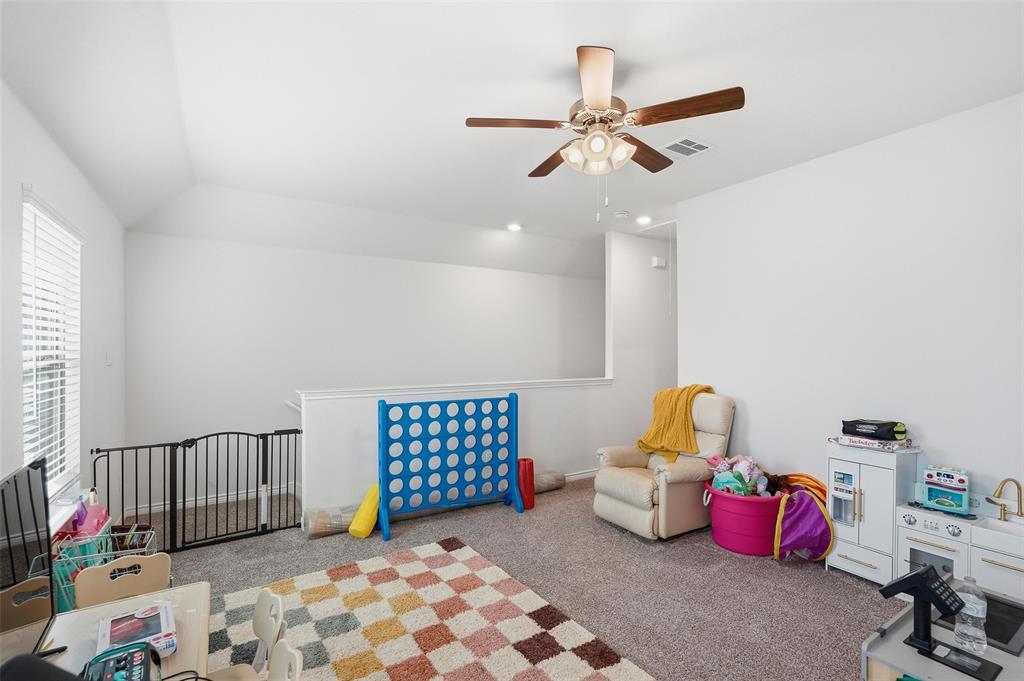 949 Philadelphia Street Fate, TX 75189 - Photo 22 of 36 a bedroom with furniture and a chandelier fan