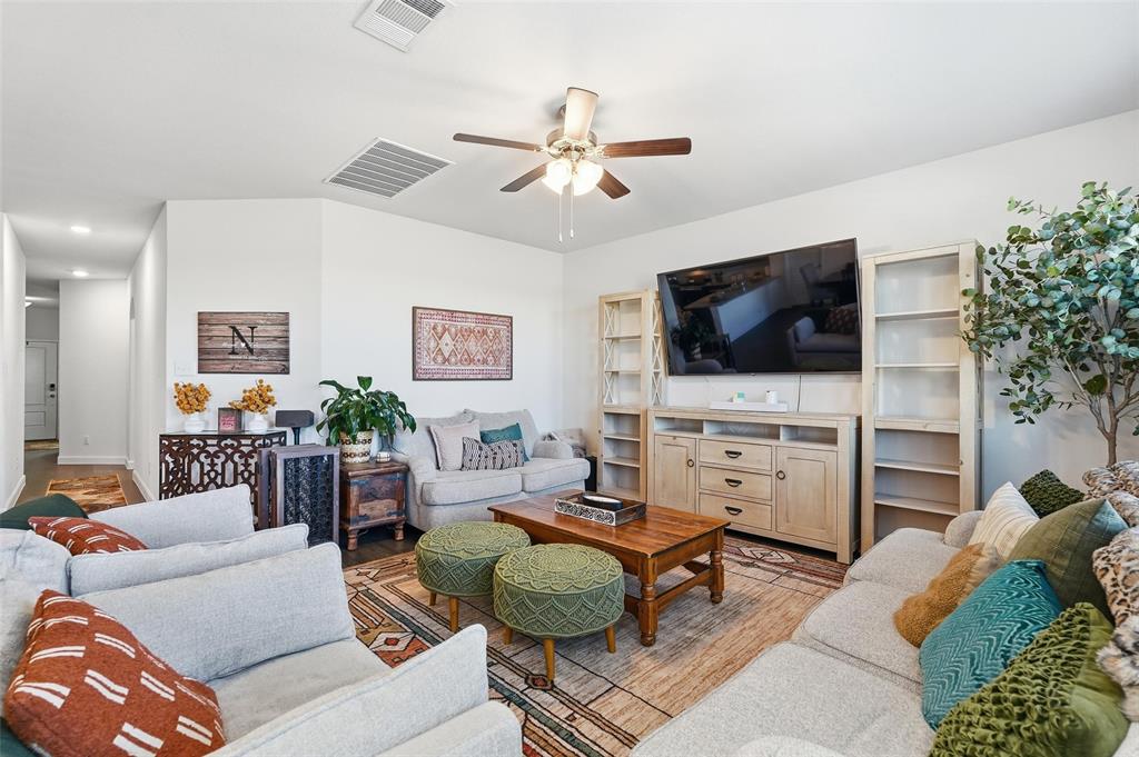 949 Philadelphia Street Fate, TX 75189 - Photo 4 of 36 a living room with furniture and a flat screen tv