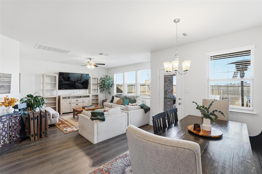 949 Philadelphia Street Fate, TX 75189 - Photo 7 of 36 a living room with furniture flat screen tv and a fireplace