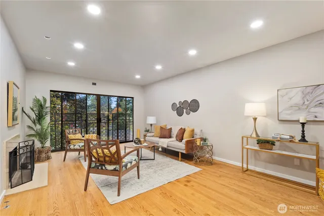 a living room with furniture large window and a table