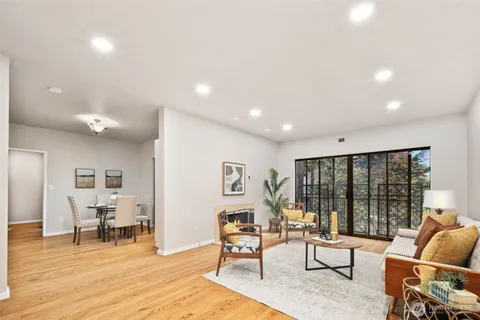 a living room with furniture and large windows