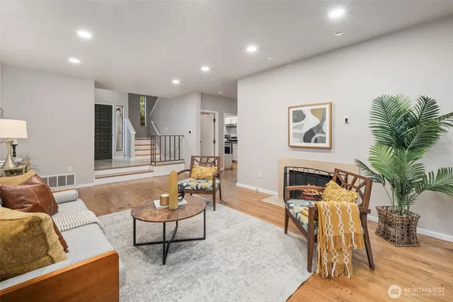 a living room with furniture and a potted plant