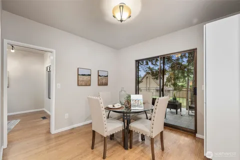 a dining room with furniture and a window