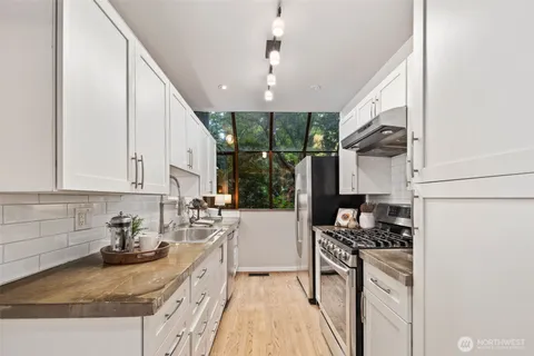 a kitchen with a sink stove and cabinets