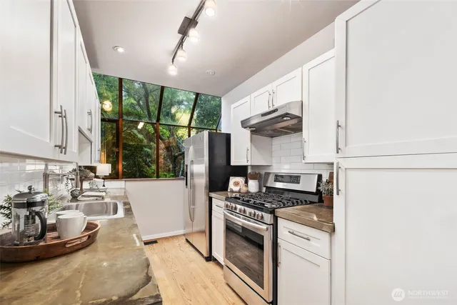 a kitchen with a stove a sink and a refrigerator
