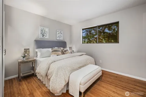 a bedroom with a bed and a painting on the wall