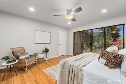 a bedroom with a bed and a large window