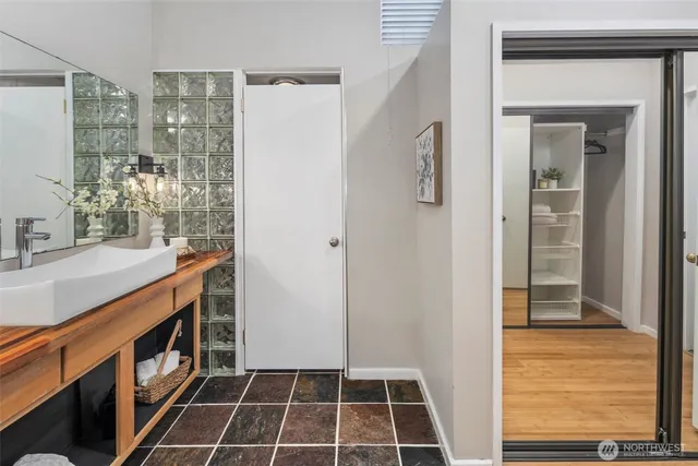 a bathroom with a double vanity sink a mirror and a shower