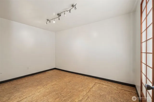 an empty room with windows and entrance