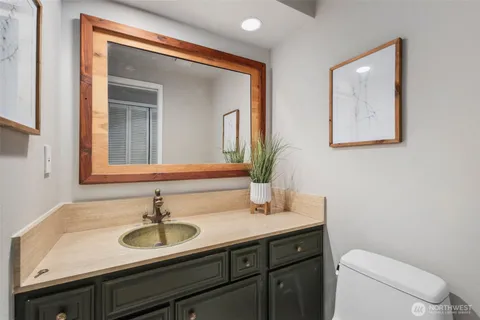 a bathroom with a toilet sink and mirror