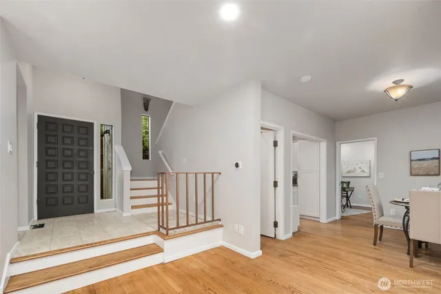 a view of a livingroom with wooden floor and stairs