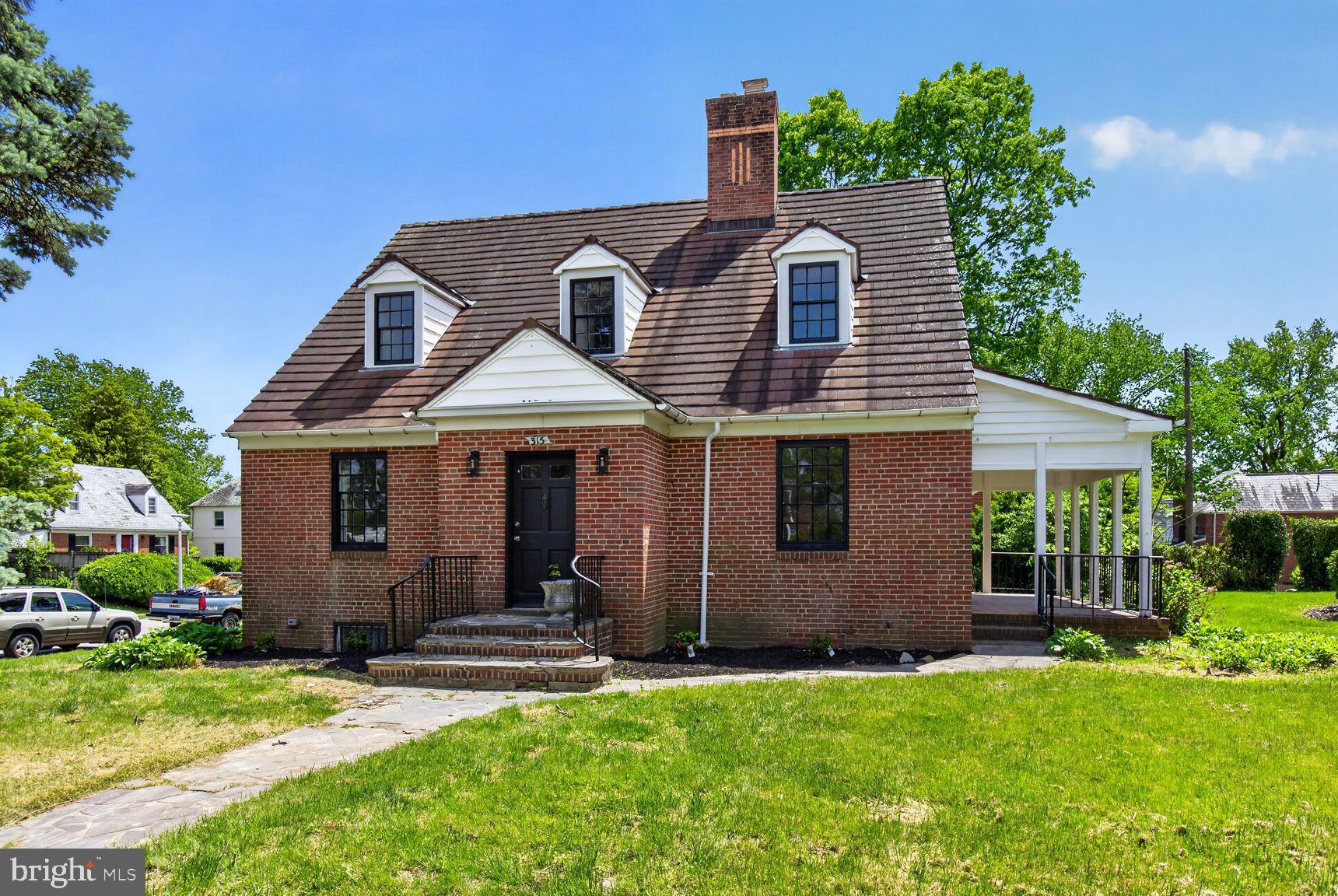 315 East Cold Spring Lane Baltimore, MD 21212 - Photo 1 of 25 a front view of a house with a garden