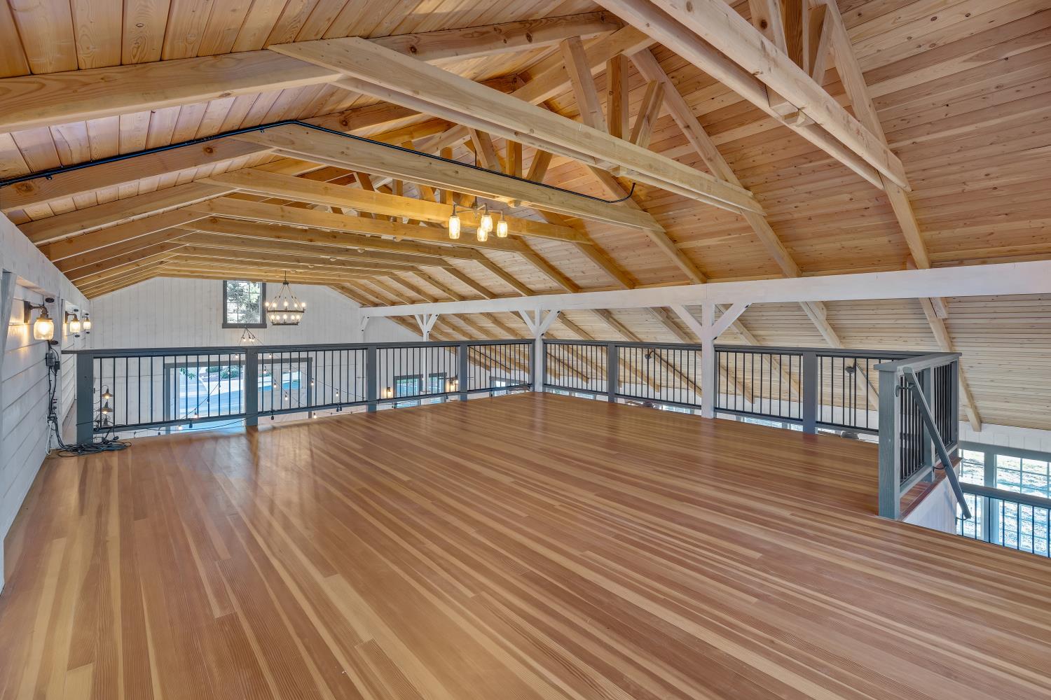2905 Virginiatown Road Lincoln, CA 95648 - Photo 60 of 86 Event Barn Loft- Open loft area featuring wood-finish flooring, exposed wood beam ceiling, and a dark metal railing