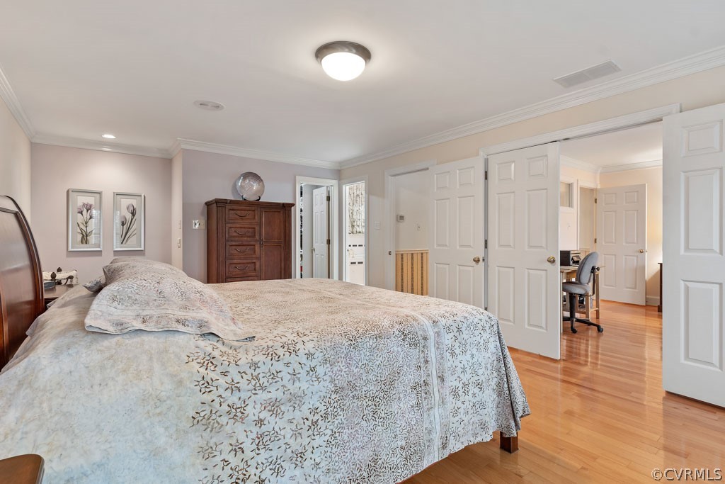 14440 Newgate Road Midlothian, VA 23113 - Photo 29 of 45 a spacious bedroom with a bed and wooden floor