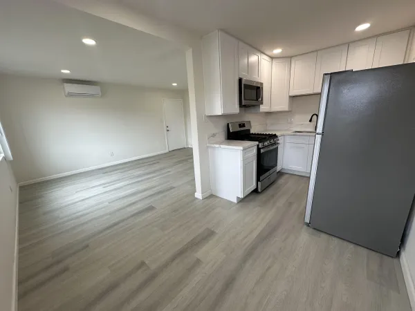 a kitchen with a refrigerator a stove top oven a sink and dishwasher