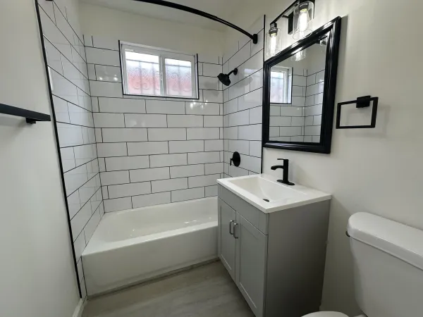 a bathroom with a bath tub a sink and a toilet