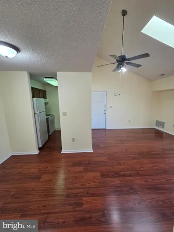 a view of a room with wooden floor and a floor to ceiling window