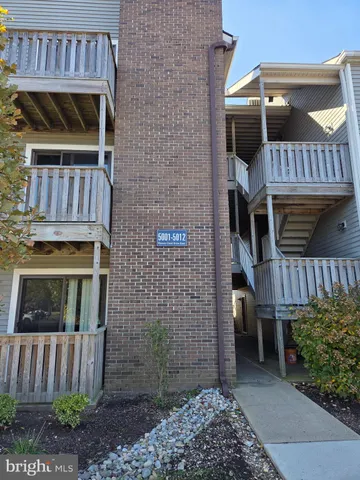 a view of balcony with wooden fence and trees
