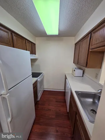 a kitchen with a refrigerator sink and stove