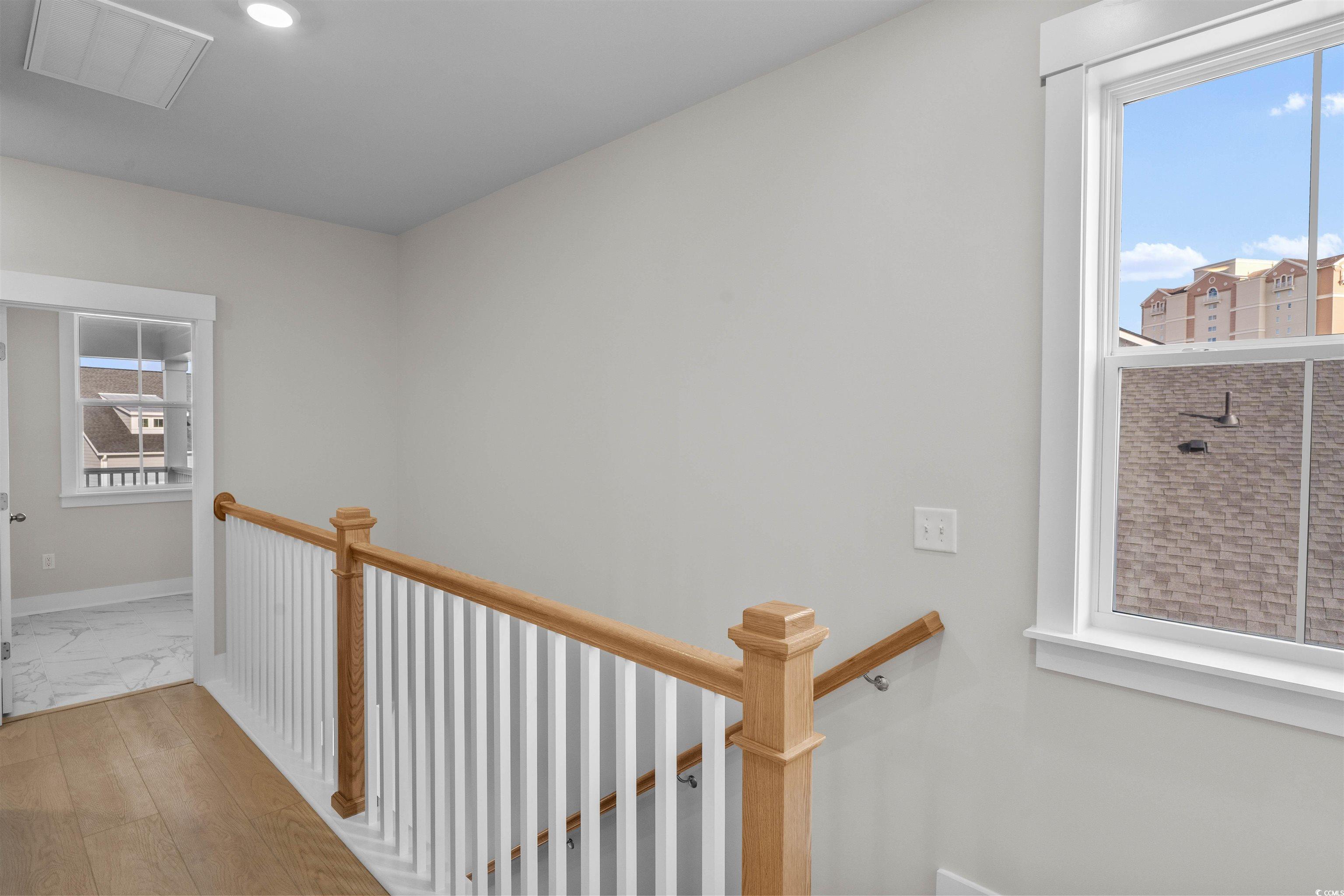 229 Atlantic Breeze Street Myrtle Beach, SC 29572 - Photo 12 of 24 Corridor featuring an upstairs landing and wood-type flooring