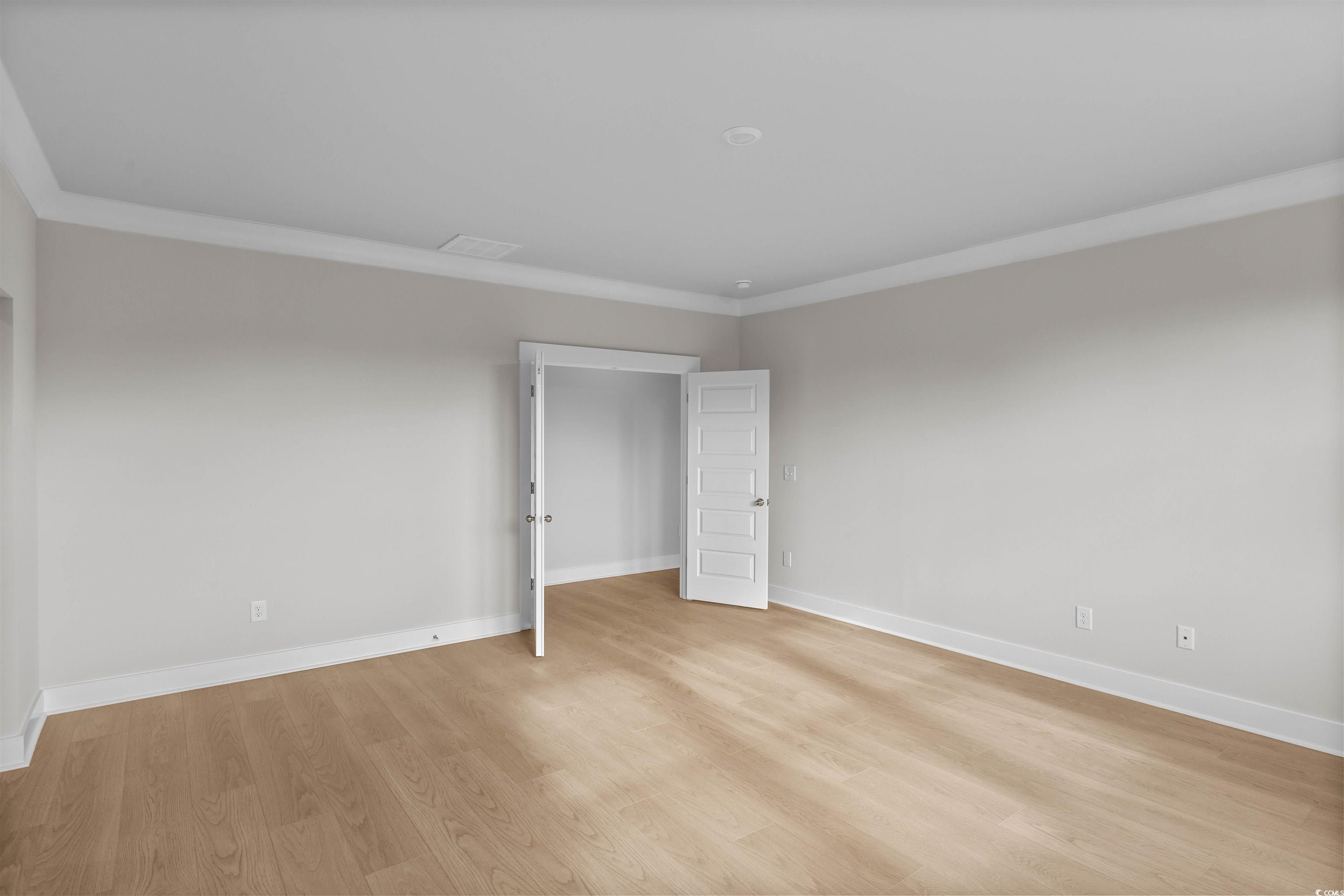 229 Atlantic Breeze Street Myrtle Beach, SC 29572 - Photo 16 of 24 Unfurnished bedroom with crown molding and light wood-type flooring